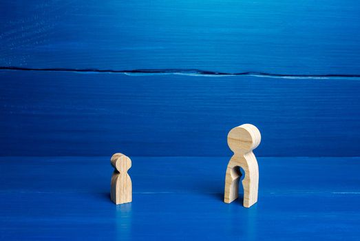 Wooden figurines of a mother with a void and a child. The concept of children leaving their parents. Deprivation of parental rights, refusal of guardianship. Surrogacy concept. Renunciation.