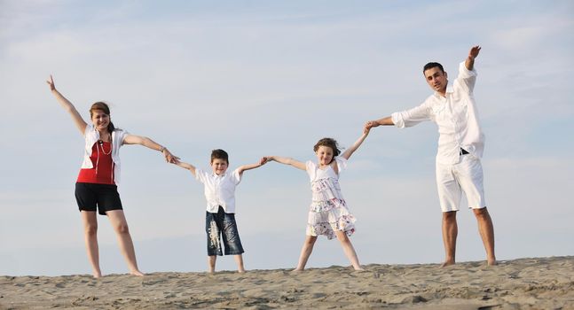 happy young family have fun and live healthy lifestyle on beach