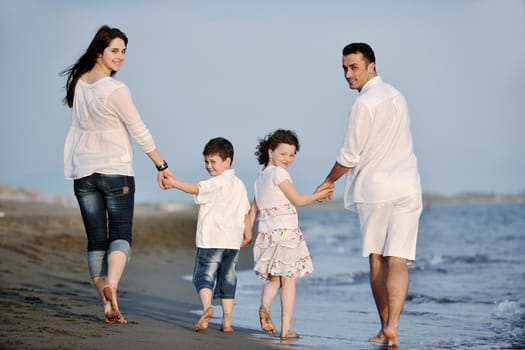 happy young family have fun and live healthy lifestyle on beach