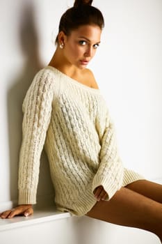 Portrait of a cute woman in sweater at home.