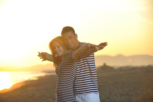 happy young couple have fun and romantic moments on beach at summer season and representing happynes and travel concept