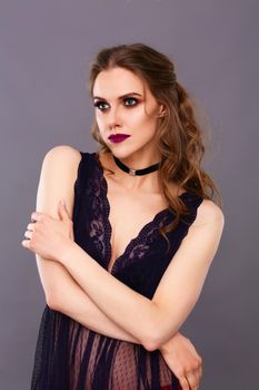 Portrait of beautiful young woman face. Isolated on gray background.