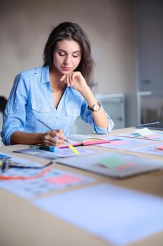 Young woman sitting at office table . Young woman.