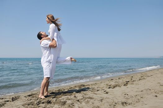 happy young couple have fun and romantic moments on beach at summer season and representing happynes and travel concept