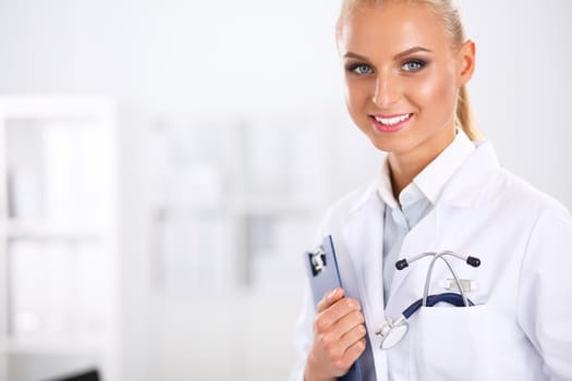 Smiling female doctor with a folder in uniform standing