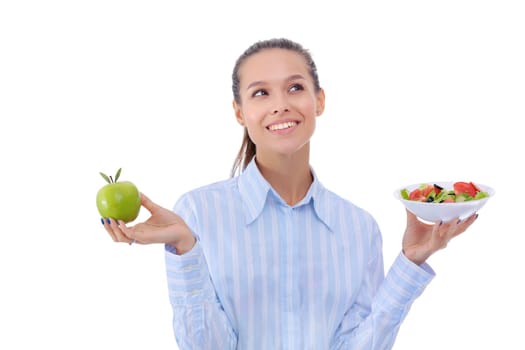 Portrait of a beautiful woman doctor holding a plate with fresh vegetables and green apple. Woman doctor.