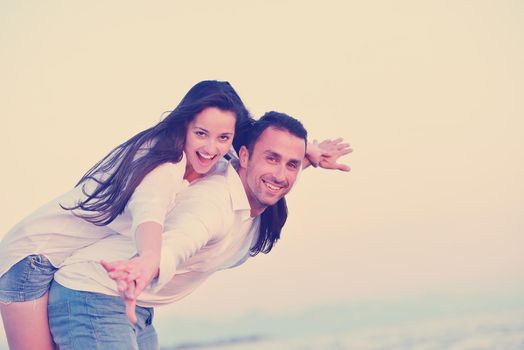 happy young romantic couple in love have fun on beautiful beach at beautiful summer day