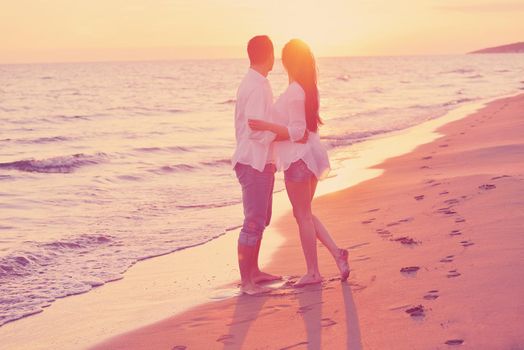 happy young romantic couple in love have fun on beautiful beach at beautiful summer day