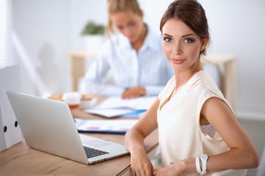 Beautiful businesswoman enjoying coffee in bright office, sitting