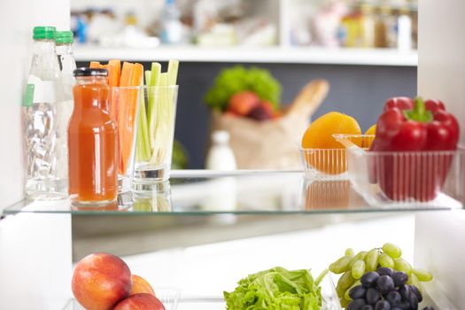 Open refrigerator with fresh fruits and vegetable. Open refrigerator.