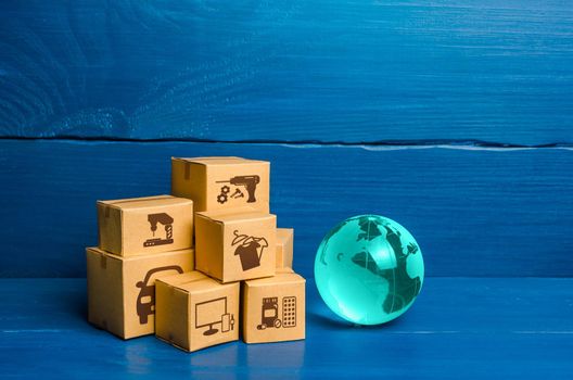 Glass globe and a bunch of boxes. Global business and world trade. Distribution of goods, import and export of products. Freight shipping delivery to new markets. Business commerce globalization.