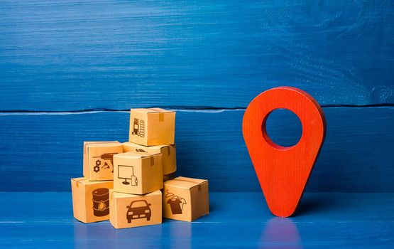 Red location pointer symbol and cardboard boxes. Transport logistics distribution delivery of goods to consumer customer. Adjusting the business to the new quarantine rules. Online sales growth