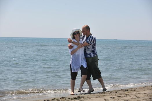 happy young couple have fun and romantic moments on beach at summer season and representing happynes and travel concept