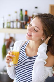 Young woman standing near desk in the kitchen. Young woman