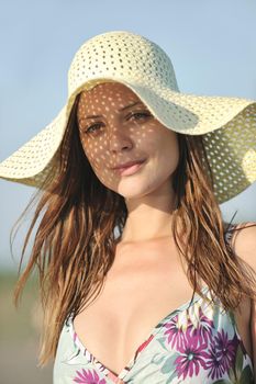 happy young woman relax on beautiful  beach at fresh summer morning and enjoy first ray of sun