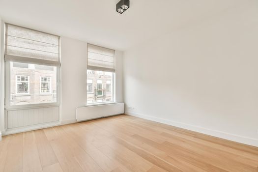 Apartment with large windows and white walls