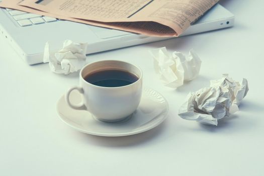 Working with crumpled paper and coffee cup on table background.