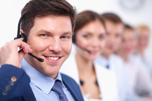 Attractive positive young businesspeople and colleagues in a call center office