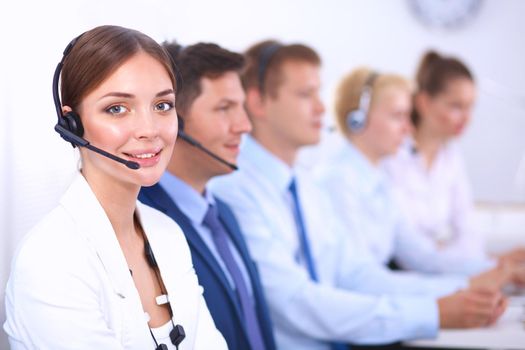 Attractive positive young businesspeople and colleagues in a call center office