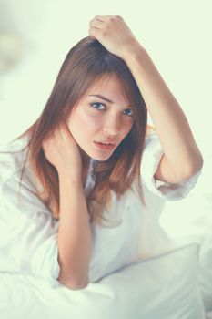 Portrait of beautiful smiling woman on bed at bedroom.