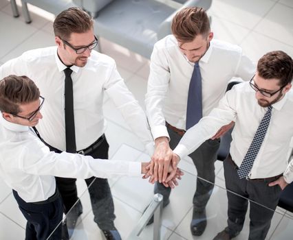 top view.a group of employees showing their unity.the concept of teamwork