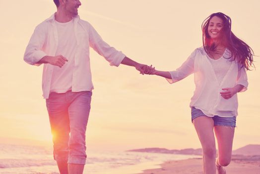 happy young romantic couple in love have fun on beautiful beach at beautiful summer day