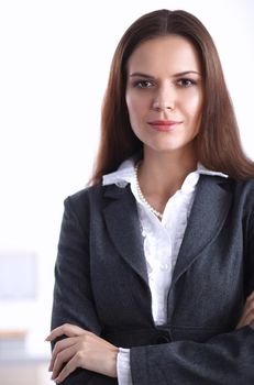 Portrait of businesswoman standing with crossed arms in office