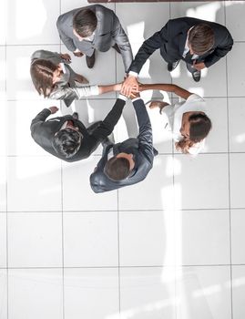 top view. a group of business people with their hands folded together. the concept of unity