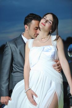 happy just married young couple celebrating and have fun at beautiful beach sunset