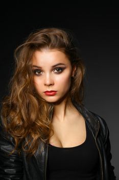 Portrait of beautiful brunette female wearing leather jacket.