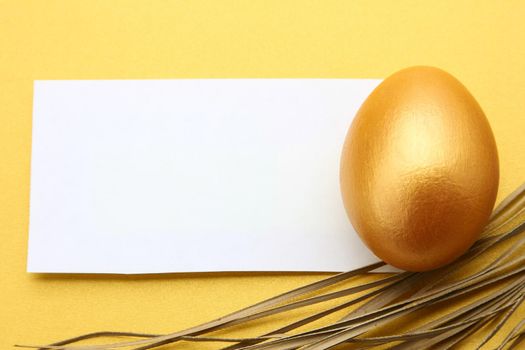 Golden egg on yellow background.