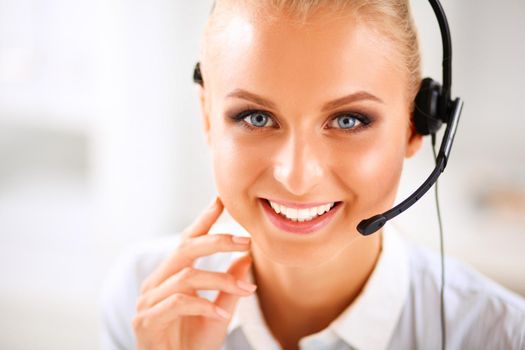 Close-up portrait of a customer service agent sitting at office.