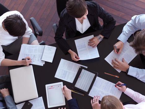 top view of  business people group on meeting, working in modern bright office indoor with tablet computer