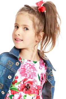 Cute little girl in dress ,denim jacket and red bow on her head . The girl is looking directly into the camera . close-up - Isolated on white background