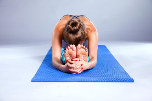 Portrait of sport girl doing yoga stretching exercise. yoga.