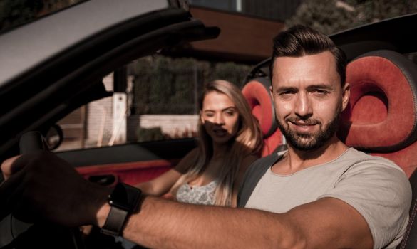 close up.a handsome man driving a luxury car.the concept of a successful lifestyle