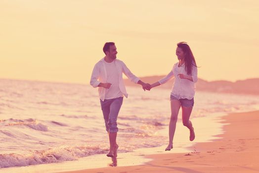 happy young romantic couple in love have fun on beautiful beach at beautiful summer day