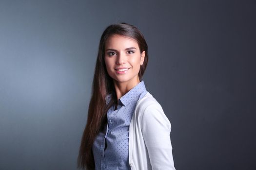 Portrait of a businesswoman , against dark background. Woman smiling. Portrait of a woman.