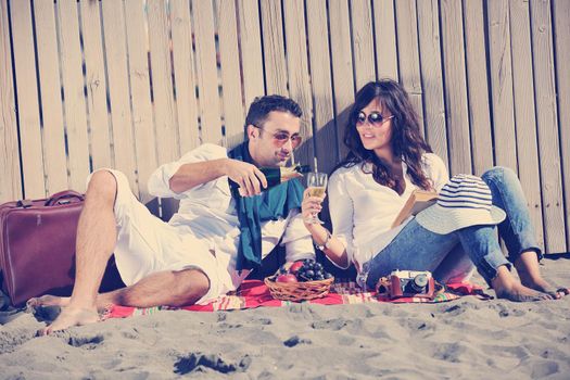 happy young couple enjoying  picnic on the beach and have good time on summer vacations