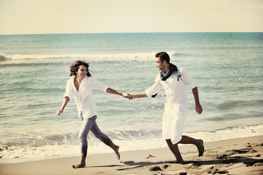 happy young couple in white clothing  have romantic recreation and   fun at beautiful beach on  vacations