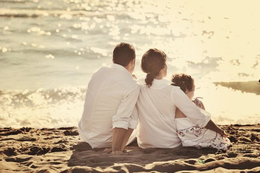 happy young family in white clothing have fun at vacations on beautiful beach 