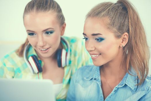 Two women working together at office, sitting