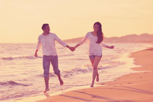 happy young romantic couple in love have fun on beautiful beach at beautiful summer day