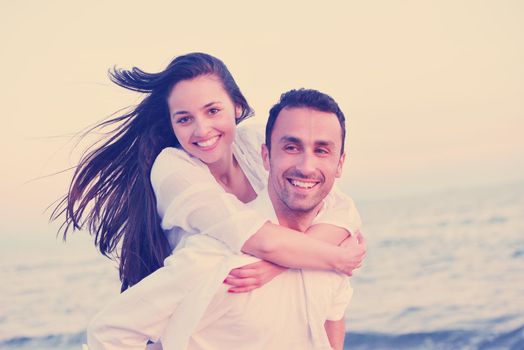 happy young romantic couple in love have fun on beautiful beach at beautiful summer day