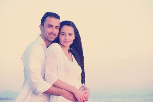 happy young romantic couple in love have fun on beautiful beach at beautiful summer day