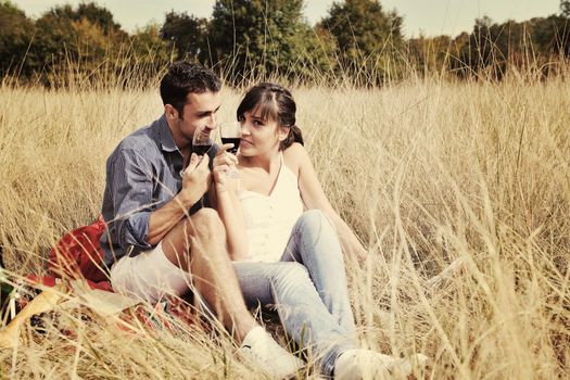 happy young couple enjoying  picnic on the countryside in the field  and have good time