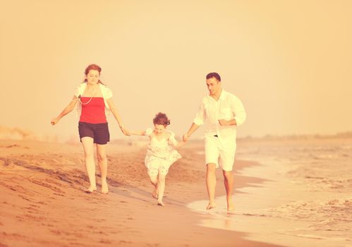 happy young family have fun and live healthy lifestyle on beach