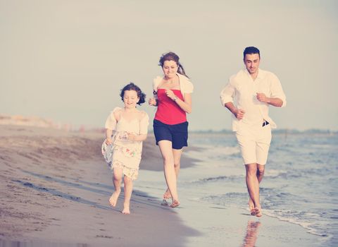 happy young family have fun and live healthy lifestyle on beach