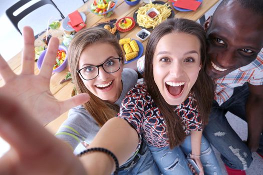 Group of people doing selfie during lunch. Self. Friends. Friends are photographed for eating.