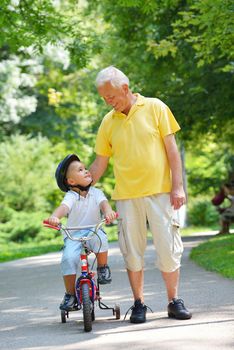 happy grandfather and child have fun and play in park